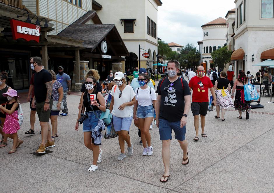 Disney Springs shoppers wear face masks and Disney-themed clothing while Walt Disney World conducts a phased reopening from coronavirus disease (COVID-19) restrictions in Lake Buena Vista, Florida, U.S. July 11, 2020. -Reuters