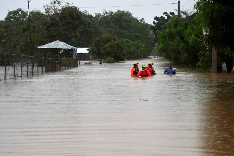 Rescue workers are seen on a flooded street, after Storm Laura passed through Santo Domingo, Dominican Republic August 23, 2020. -Reuters