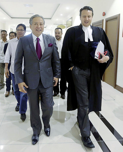 Filepix taken on April 11 shows Datuk Seri Anifah Aman (front, left) walking beside his lawyer Tengku Fuad Tengku Ahmad, at the High Court in Kota Kinabalu.