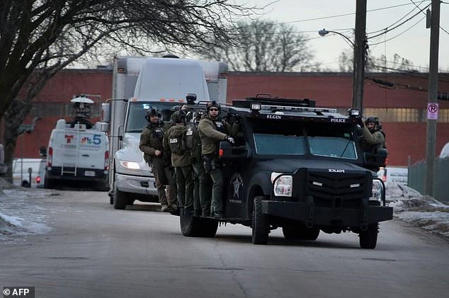 Police secure the area following a shooting at the Henry Pratt Company in Aurora, Illinois. — AFP