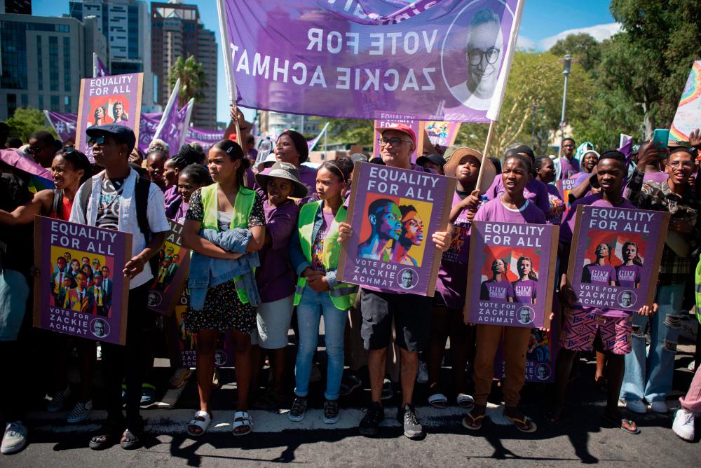 Zackie Achmat(C) an openly gay veteran activist, who is standing as an independent candidate in the upcoming general elections, joins thousands of people, many in colourful outfits, take part in the annual Cape Town Pride Parade through the centre of the city, which is to celebrate and raise awareness on the issues affecting the LGBTQI+ community, on March 02, 2024, in Cape Town/AFPPix