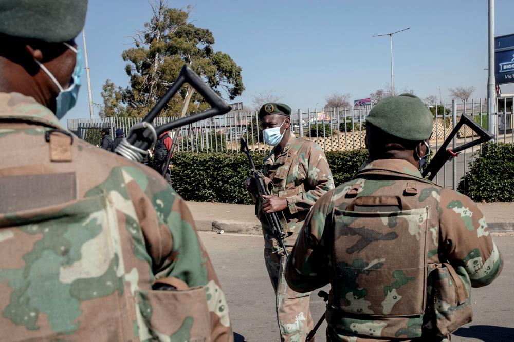 South Africa Defence Force (SANDF) soldiers stand guard in front of Maponya Mall in Soweto, on July 14, 2020. – AFP