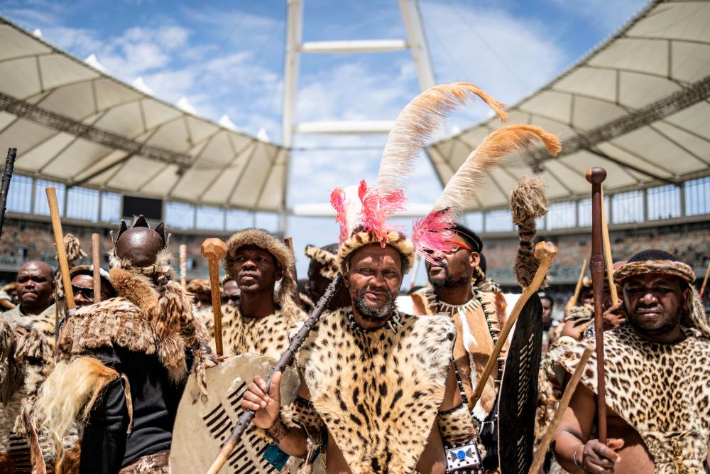 Amabutho, Zulu King regiments, clad in traditional dresses and carrying shields and sticks, are seen at the Moses Mabhida Stadium in Durban/AFPPix