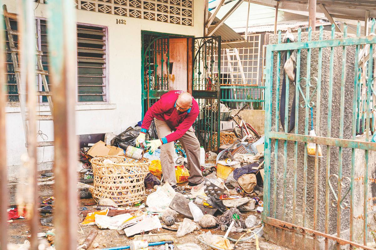 A council member sorting through piles of trash at the premises. – CHANDRA SAGARAN/THESUN