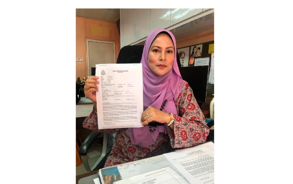 Samsiah with a police report she lodged over the SDs.