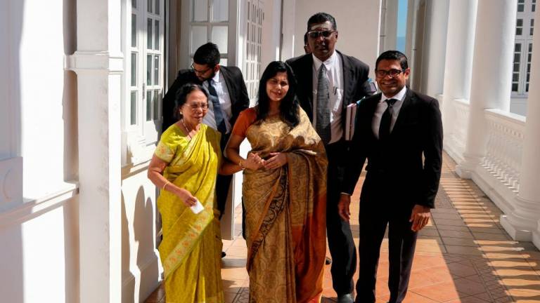 Filepix of Meeriam Rosaline Edward Paul, 59, (front, center), on Dec 12, 2019, after filed an interim application at the Ipoh High Court to obtain unrestricted access to Samy Vellu, apart from a monthly alimony payment of RM25,000. — Bernama