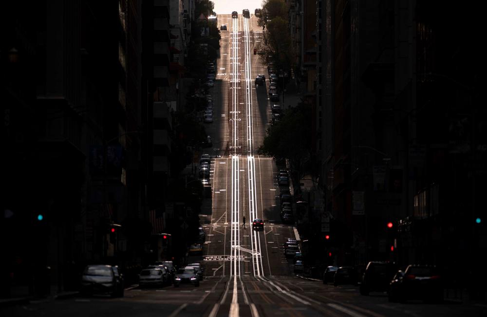 California Street, usually filled with cable cars, is seen empty in San Francisco, California on March 18, 2020. — AFP