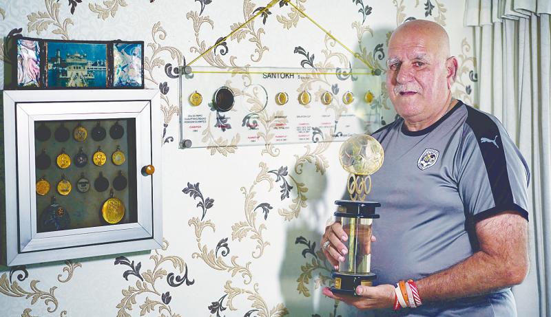 Santokh with the custom-made Olympics trophy. — Sunpix by Norman Hiu