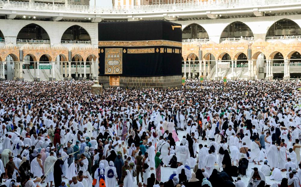 This file photo taken on August 11, 2019 shows Muslim pilgrims performing the Tawaf al-Ifada, a mandatory circumambulation around the Kaaba, Islam's holiest shrine, at the climax of the annual Hajj pilgrimage at the Grand Mosque in Saudi Arabia's holy city of Mecca. - AFP