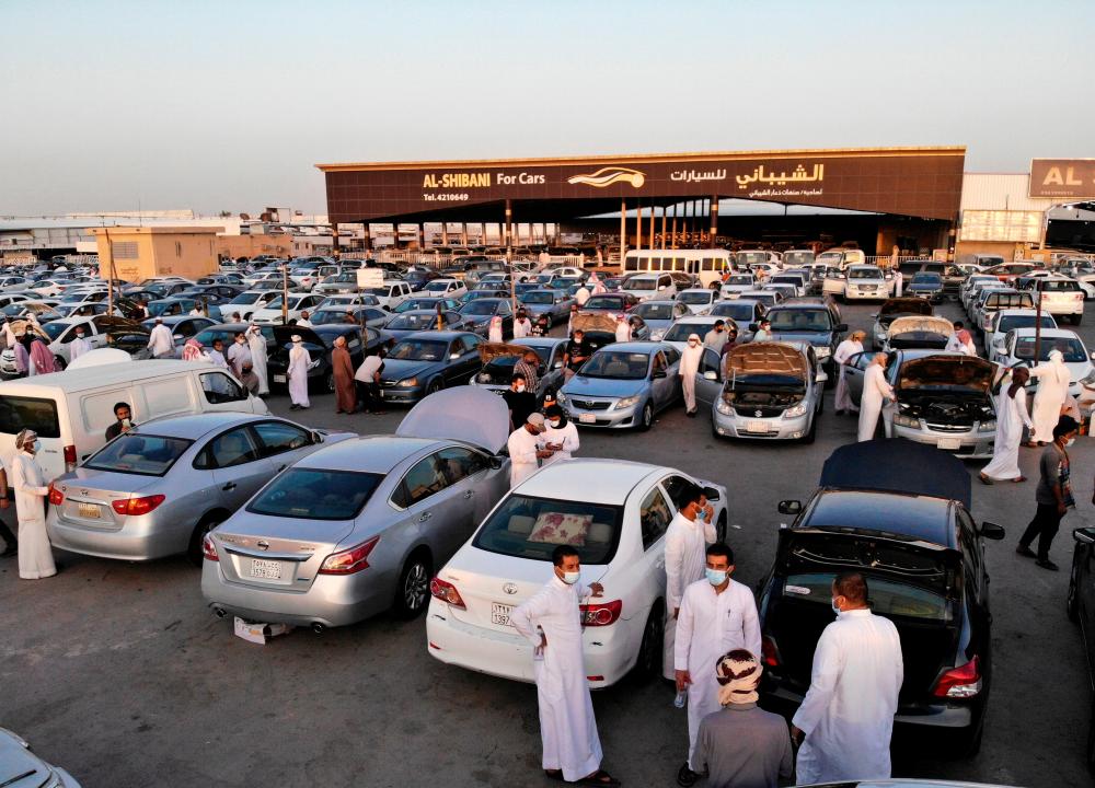 People gather to buy vehicles before the expected increase of VAT to 15% in Riyadh on June 27. – REUTERSPIX