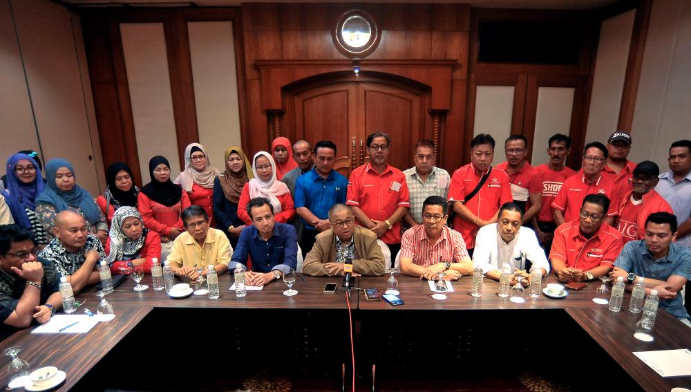 Labuan Bersatu pro tem chief Datuk Suhaili Abd Rahman (seated, 5thR) with other fellow party members at the Dorsett Grand Hotel, on Sept 14, 2019. — Bernama