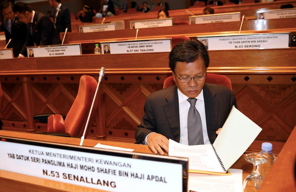 Sabah Chief Minister Datuk Seri Mohd Shafie Apdal reviews the contents of the file before the commencement of the First Meeting of the Second Sabah Legislative Assembly of the 15th Sabah State Assembly Building, on April 15, 2019. — Bernama