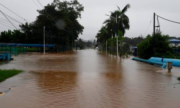 One of the main roads into Donggongon is impassable for all types of vehicles as floods hit the area following heavy rains from yesterday. - Bernama