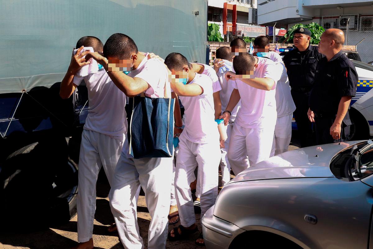 Some of the 13 students from Lahad Datu Vocational College arrive at the High Court today. - BERNAMA