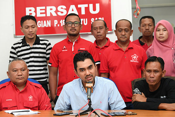 Bersatu information chief Khairul Firdaus Akbar Khan (seated, center) speaks during a press conference at the Batu Sapi Bersatu office today. — Bernama