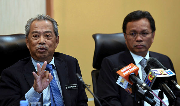 Home Minister Tan Sri Muhyiddin Yassin (left) speaking at a press conference after chairing the Committee on the Management of Foreign Nationals meeting with Sabah Chief Minister Datuk Seri Mohd Shafie Apdal (right) at Kota Kinabalu today. — Bernama