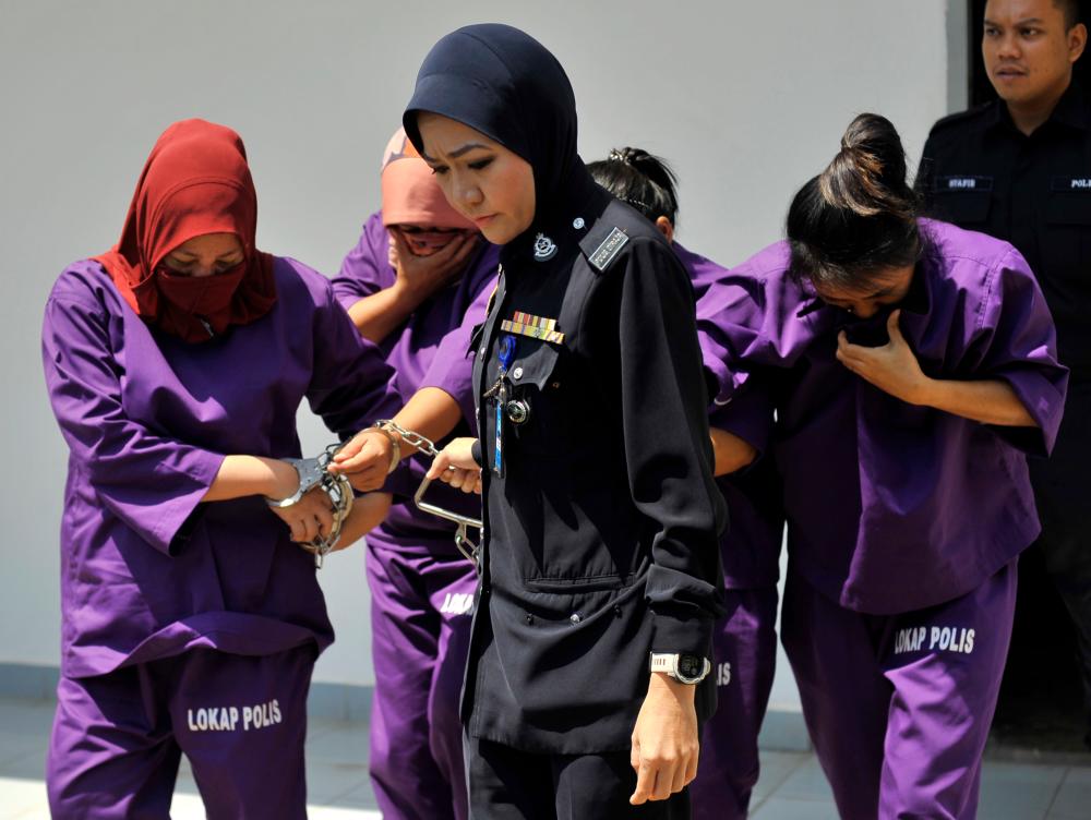 A logistics worker Maria Resi Pora, 26, (R) pleaded guilty in Labuan magistrates’ court on charges of concealing the birth of a child and illegally allowing the disposal of the foetus at a sewage treatment on November 3. - Bernama