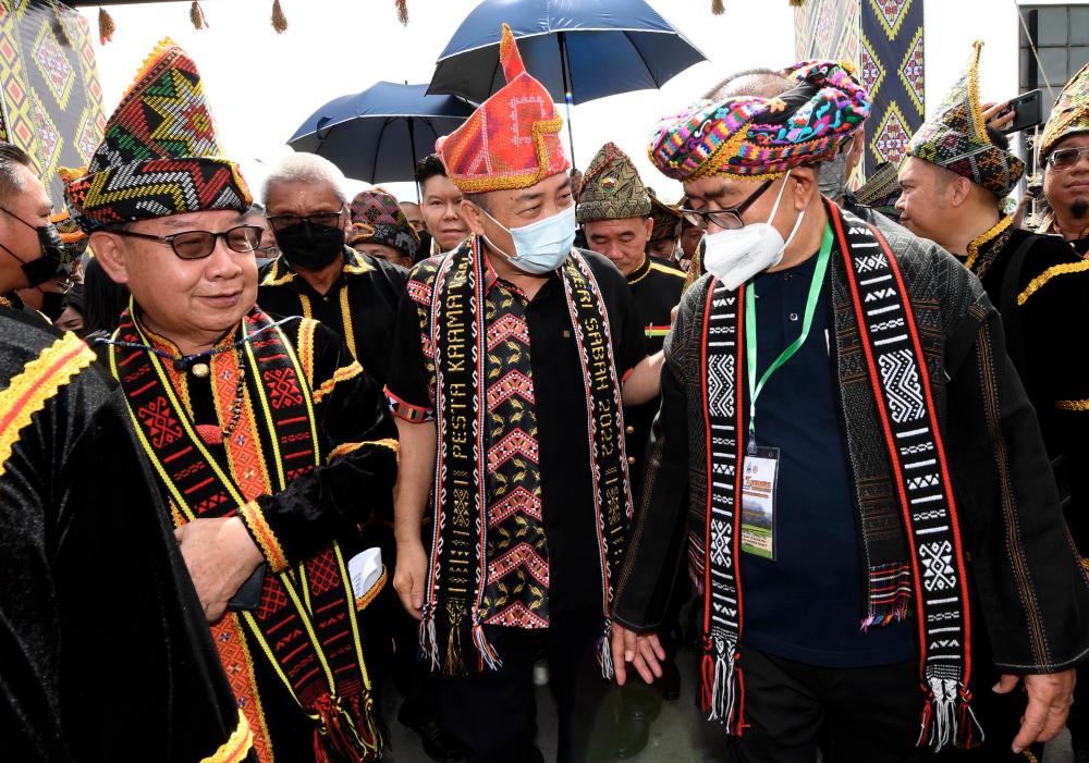 KOTA KINABALU, May 30 - Sabah Chief Minister Datuk Seri Hajiji Noor (center) accompanied by Sabah Deputy Chief Minister Datuk Dr Jeffrey Kitingan (left) and Sabah and Sarawak Affairs Minister Datuk Dr Maximus Ongkili (right) when arriving to officiate the opening ceremony of the Festival Kaamatan in Hongkod Koisaan today. BERNAMAPIX