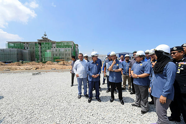Home Minister Tan Sri Muhyiddin Yassin (3rd from L) visits the construction site of the Kota Kinabalu district police headquarters on April 6, 2019. — Bernama
