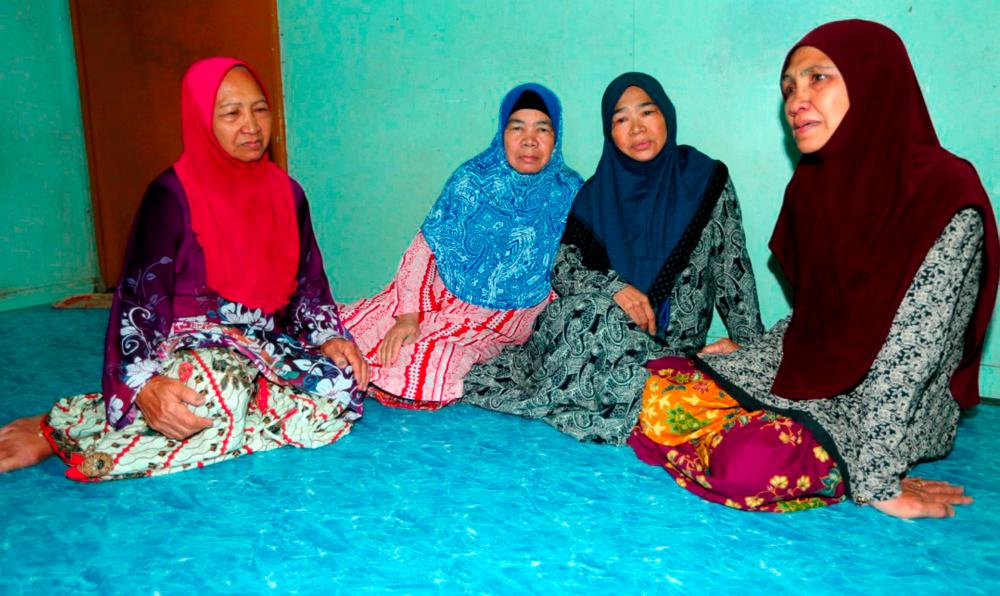 From left: Distraught sisters of Dr Rumihati, Taisah, Jeidah, and Zaiton, when met at their home in Putatan, on Dec 7, 2019. — Bernama