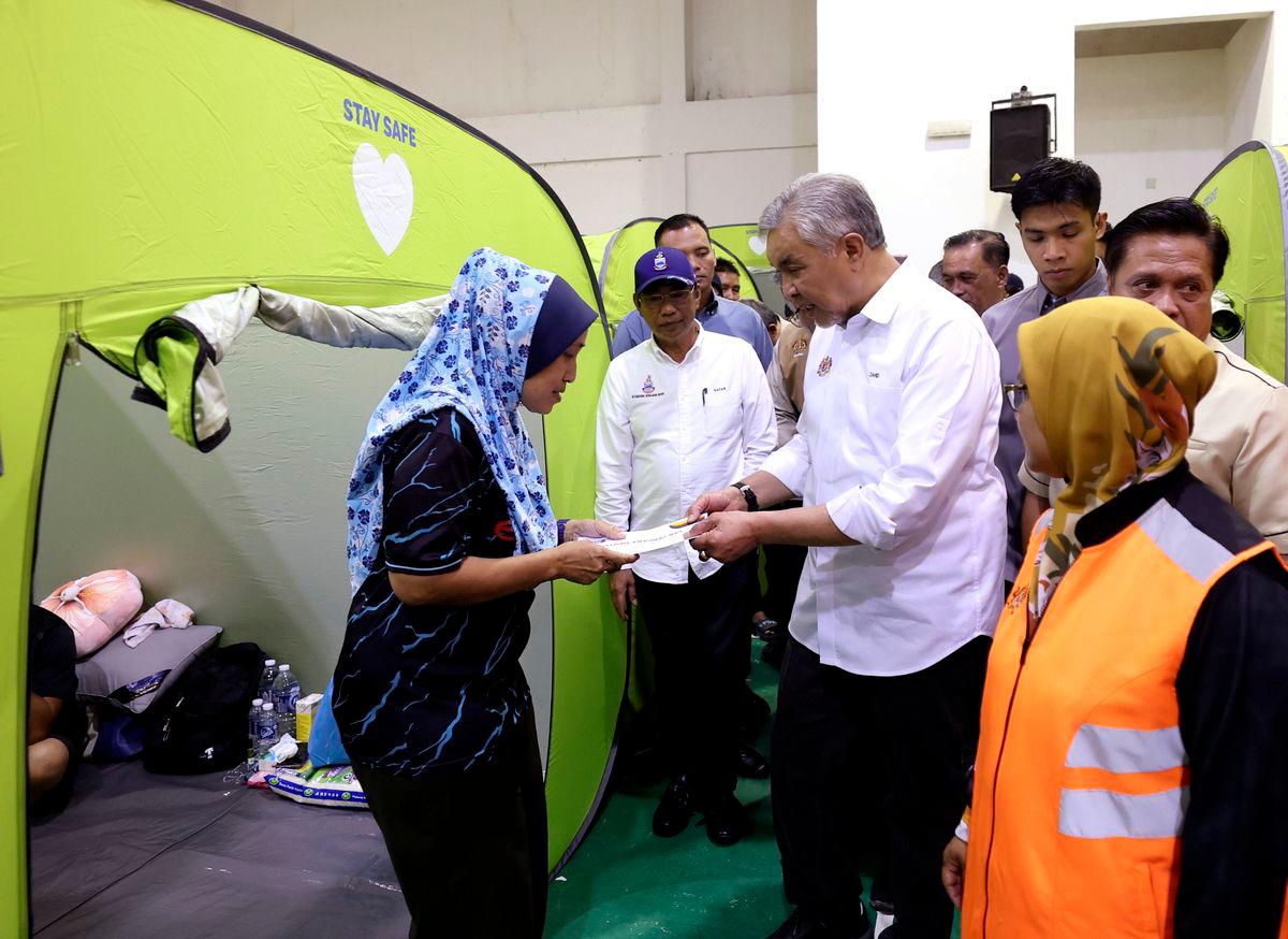 Gambar Hiasan Sahaja: Timbalan Perdana Menteri Datuk Seri Ahmad Zahid Hamidi menyantuni mangsa banjir di Pusat Penempatan Sementara (PPS) Keramat Putatan, semalam -fotoBERNAMA