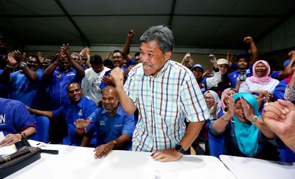 Barisan Nasional candidate Datuk Seri Mohamad Hasan celebrates his victory after unofficial results for the Rantau by-election were announced in the Barisan Nasional main campaigning room in Rantau, Negri Sembilan on April 13, 2019. — BBX