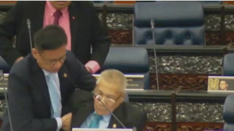 A screengrab of the incident, as Subang MP, Wong Chen (L) rushes to the rescue of Datuk Mansor Othman, on Oct 21, 2019.