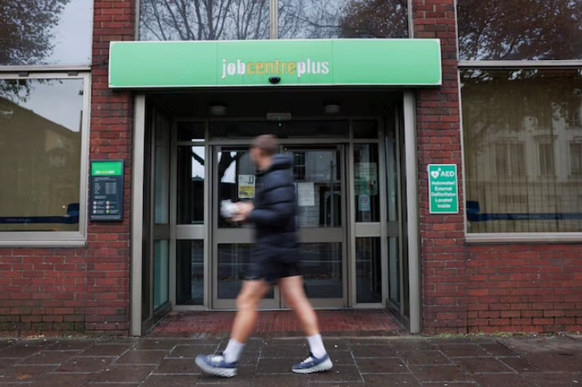 A passer-by walks past a job centre in Borough, in London, Britain, December 1, 2024. - REUTERS