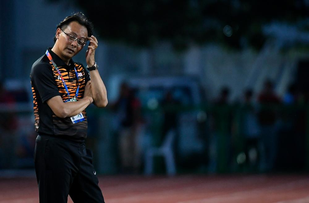 Head coach of the national under-23 football team, Datuk Ong Kim Swee reacts after losing 1-3 to Cambodia in the men’s football match between Malaysia and Cambodia at the Rizal Memorial Stadium in Manila today. - Bernama