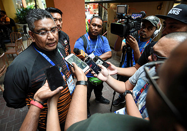 Malaysia’s chef de mission Datuk Megat Zulkarnain Omardin answers questions from reporters after his arrival at the 2019 SEA Games in Manila — Bernama