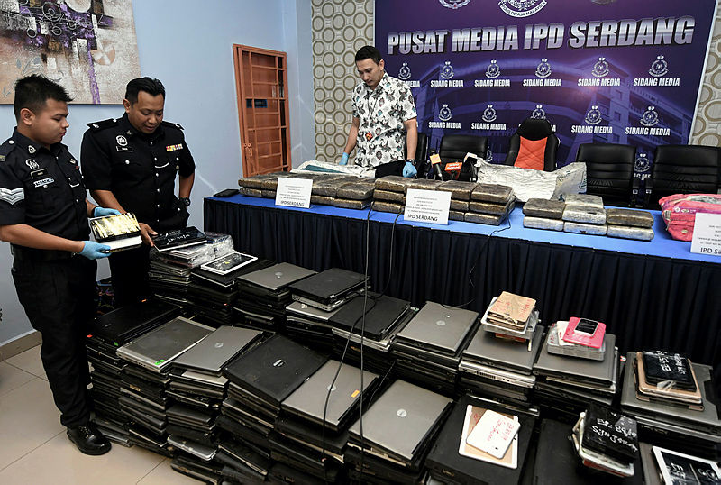 Police display the devices seized during the raids. — Bernama