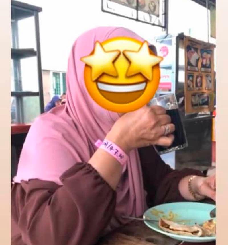 A picture of a woman wearing a Covid-19 quarantine wrist tag and dining at a restaurant in Bandar Meru Raya went viral on social media. — Pix from social media