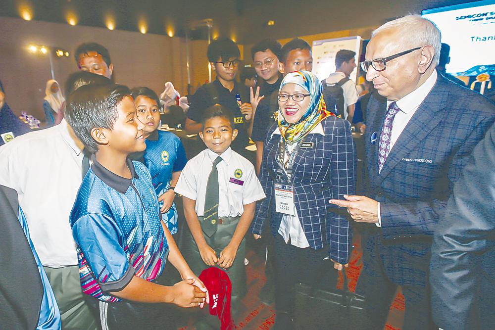 From right: Ajit and Prof. Madya enjoy a light moment with students who were present at the launch.
