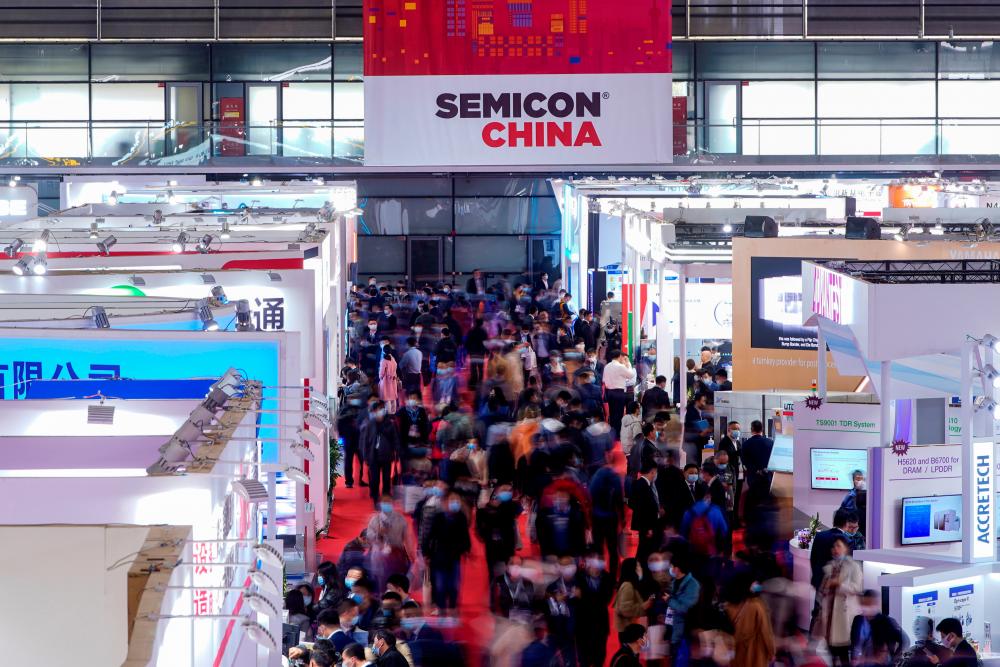 Visitors throng the booths at Semicon China, a trade fair for semiconductor technology, in Shanghai on Wednesday. – REUTERSPIX