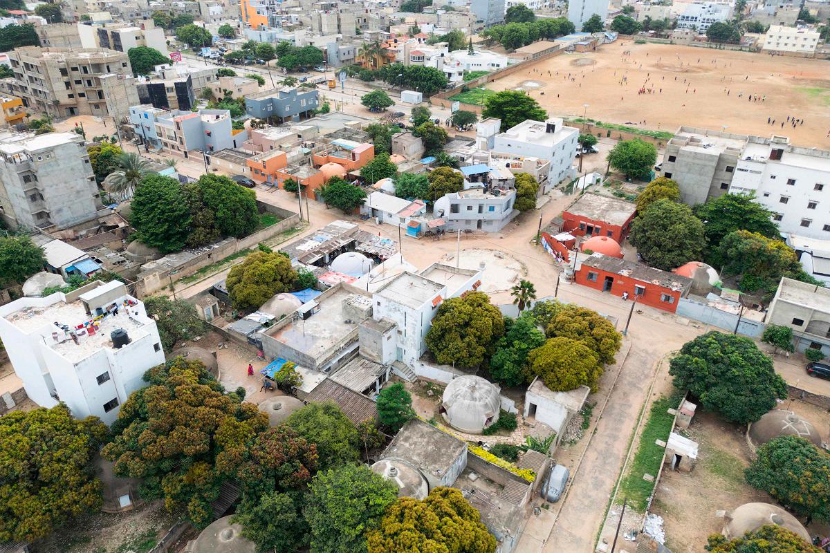 An aerial view of bubble houses in Ouakam, a suburb of Dakar, on August 27, 2025. It’s 1950s space-age aesthetic sits in sharp contrast with the boxy, multi-storey apartments being built nearby. - Elena BOFFETTA / AFP