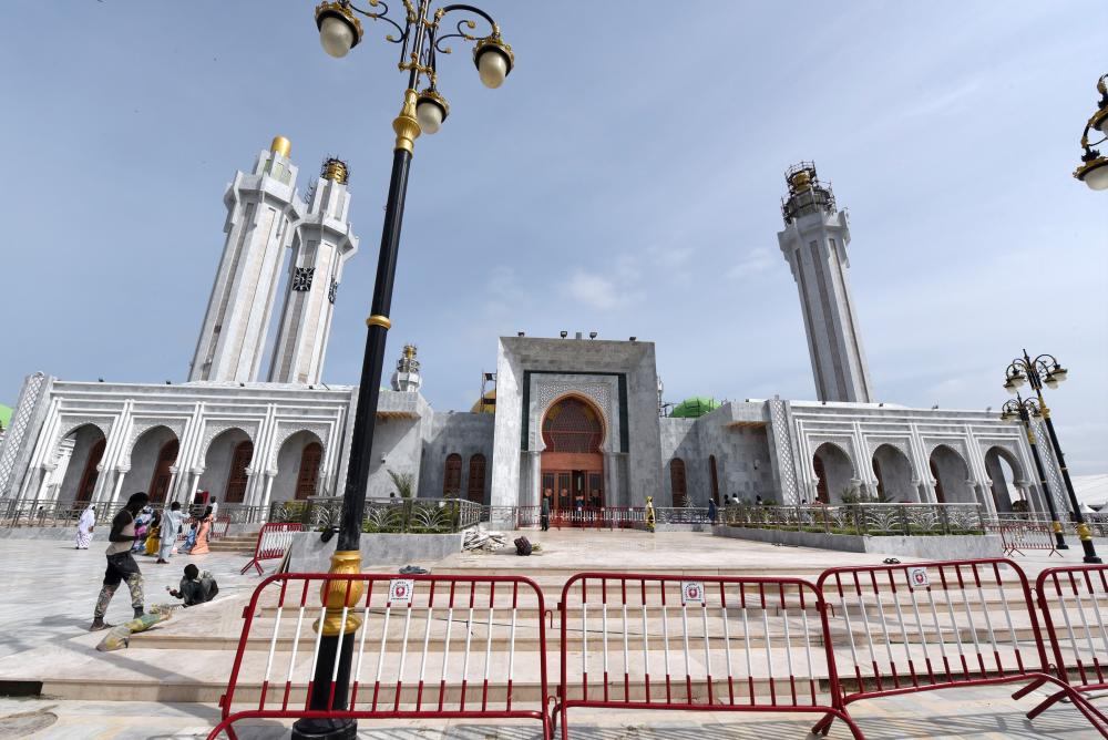People wander on the esplanade of the Great Mosque of the Mourides in Dakar, on September 25, 2019 before the inauguration that will take place on Sept 27, 2019. — AFP