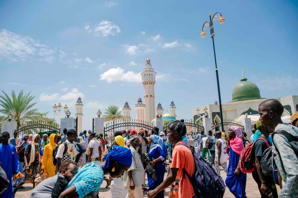 Pilgrims walk past the Great Mosque of Touba on September 25, 2021, the day before the Grand Magal of Mourides, the largest annual muslim pilgrimage in Senegal with hundreds of thousands making the pilgrimage each year. AFPpix
