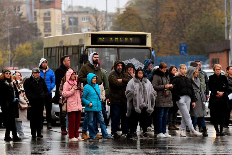 People stand in silence near the railway station in Novi Sad on November 15, 2024, two weeks after 14 people died when a roof at the city’s train station collapsed - AFPpix