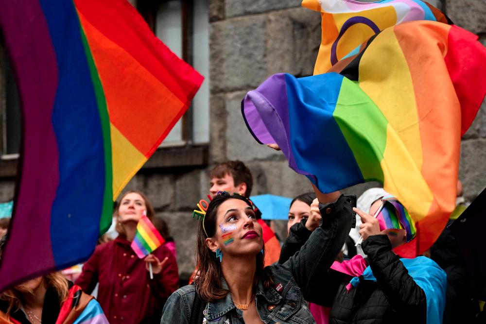 LGBT activists wave rainbow flags during a pride march, in Belgrade, on September 17, 2022. - AFPPIX