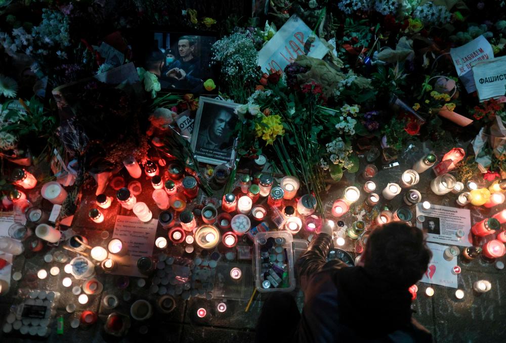 This photograph taken on March 1, 2024, shows a portrait of late Russian opposition leader Alexei Navalny with flowers and candles layed in tribute at a makeshift memorial in front of the Russian Embassy in Belgrade/AFPPix