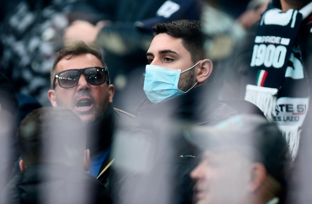 General view of a Lazio fan wearing a face mask amid concern following a coronavirus outbreak in Italy. - Reuters
