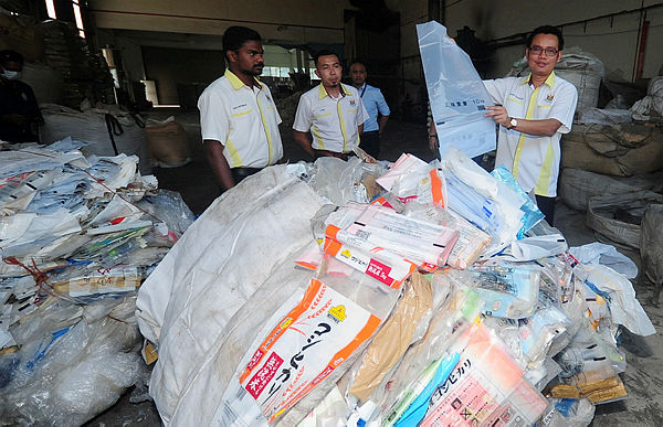 MPK licensing deputy director, Mohd Fahrulisa Md Isa (right), shows the plastic waste that is kept in the factory at Air Hitam, Klang today.