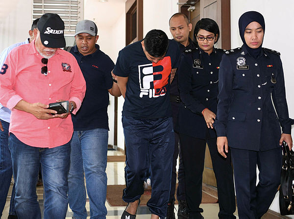 Rosman Jamal, 39, (c) was charged in the Shah Alam sessions court today on two charges of receiving RM1.14 million from two individulas without a valid license between 2016 and 2017. — Bernama