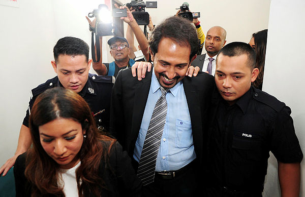 Gnanaraja Gnanasundram, a former Datuk Seri, being escorted in court. Picture from April 3, 2019. — Bernama