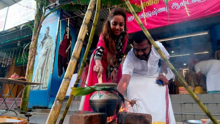 A couple prepare the Ponggal (sweet rice) for Ponggal celebration in Klang, on Jan 15, 2019. — Bernama