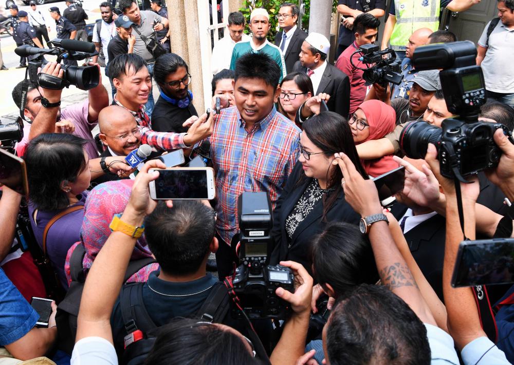 Muhd Asyraf Mohd Kassim, brother of the late firefighter Muhammad Adib, was met by reporters after an inquest to determine the cause of his brother’s death released its conclusions, at the Shah Alam Court Complex Coroner’s Court today. - Bernama