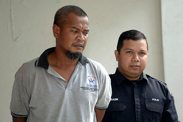 A lorry driver, Mohammad Ridzuan Misropi, 41, (L) was brought to the Shah Alam magistrate’s court today for allegedly causing the unintentional death of his wife at their home on Feb 7 this year. — Bernama