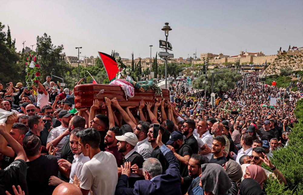 Palestinian mourners carry the casket of slain Al-Jazeera journalist Shireen Abu Aklel, during her funeral procession from the church toward the cemetary, in Jerusalem, on May 13, 2022. AFPpix