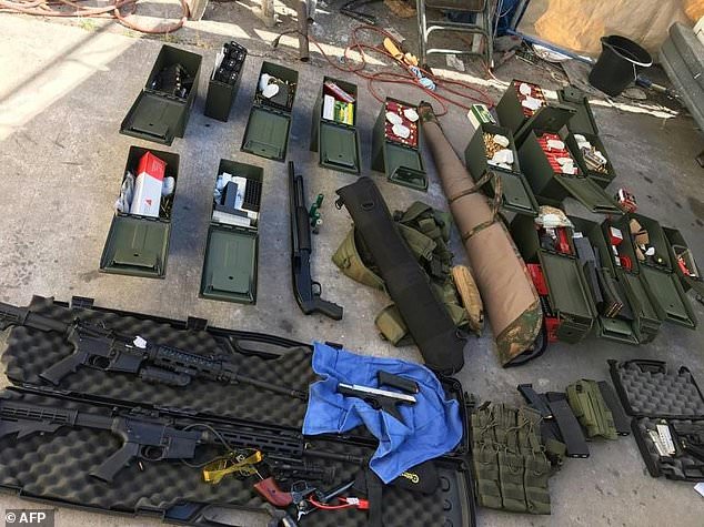 Multiple firearms, hundreds of rounds of ammunition and tactical gear seized from suspect Rodolfo Montoya is pictured in a photo released by the Long Beach Police Department. — AFP
