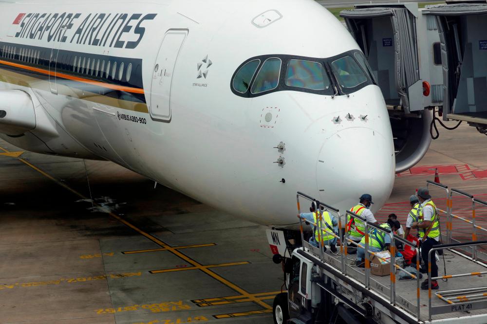 File photo: A Singapore Airlines Airbus A350-900 plane undergoes maintenance at Changi Airport in Singapore October 24, 2020. REUTERSpix